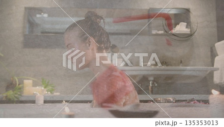 Soaking woman relaxing in spa-like bathroom, with lit candles, folded towels and circular mirror Soaking woman relaxing in spa-like bathroom, with lit candles, folded towels and circular mirror 135353013