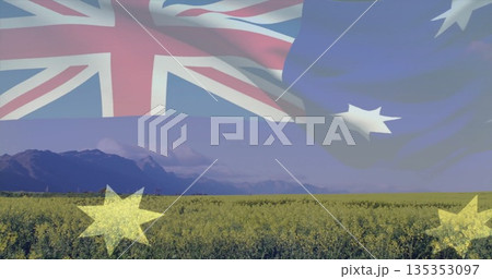 Displaying Australian flag merging into canola field in clear sky with mountain backdrop Displaying Australian flag merging into canola field in clear sky with mountain backdrop 135353097
