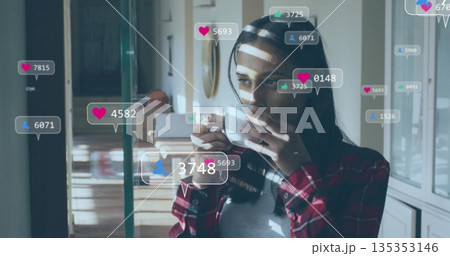 Sipping woman in red plaid holding white mug in kitchen, with social media icons, copy space 135353146