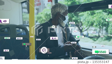 Holding smartphone, commuter wearing dark blazer and protective mask viewing floating icons on bus 135353147