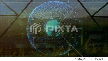 Projecting holographic globe orbiting with blue matrix points at window overlooking grassy field 135353219