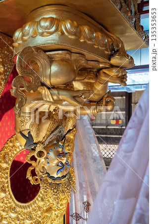 Golden statue of deity at Buddha Tooth Relic Temple in Chinatown, Singapore with intricate details and vibrant colors 135353653