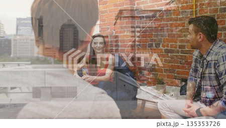 Writing notes woman in red top and dark jeans at coworking lounge, with notebook, succulent plant 135353726