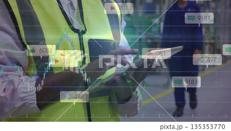 Inspecting worker in safety vest tapping tablet in warehouse, metal racks yellow floor markings Inspecting worker in safety vest tapping tablet in warehouse, metal racks yellow floor markings 135353770
