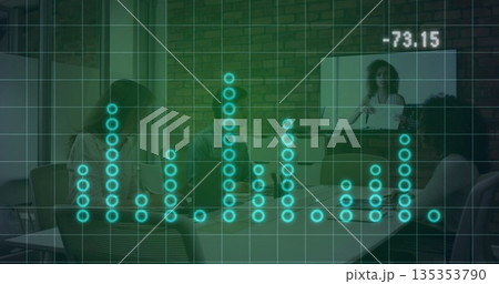 Meeting team in business casual attire discussing strategy in conference room, with laptops screen 135353790