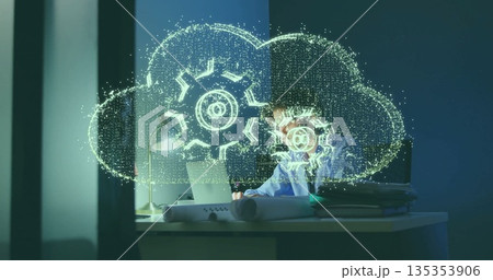 Focusing IT pro wearing shirt typing on laptop in dim office, with cloud hologram, copy space 135353906