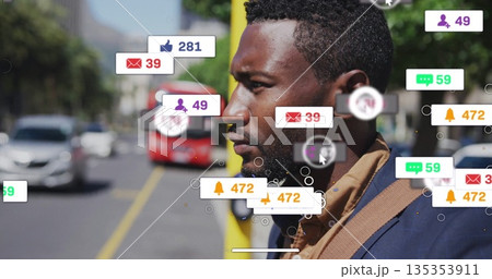Man in blazer standing by yellow pole on street with floating social icons, vehicles, copy space 135353911