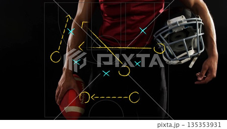 Gripping football and helmet, adult male player posing in sports studio with play diagram overlay 135353931