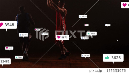 Red-jersey player shooting over blue-jersey defender in gym court, with media notification icons Red-jersey player shooting over blue-jersey defender in gym court, with media notification icons 135353976