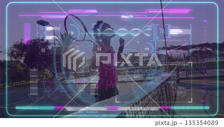 Gripping tennis racket in magenta top activating AR display on outdoor court with net, showing data Gripping tennis racket in magenta top activating AR display on outdoor court with net, showing data 135354089