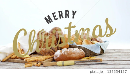 Bread assortment sitting on tabletop, with wicker basket, serrated knife, Merry Christmas lettering 135354137