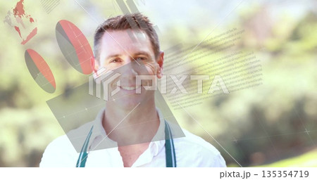 Standing smiling man wearing white shirt with green suspenders in park, with 3D charts and panels 135354719