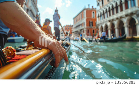 Close Up of Gondolier Hand Navigating a Traditional Boat in Venice Canal Sunny Day 135356883