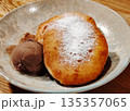Pancakes with powdered sugar with a scoop of chocolate ice cream. 135357065