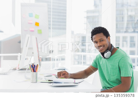 African American man working on design with computer and color wheel in design studio, copy space African American man working on design with computer and color wheel in design studio, copy space 135359378