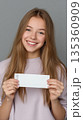 Teen showing a blank event ticket ready for custom entertainment graphics 135360909