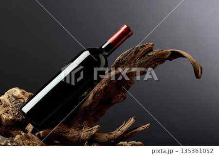 Bottle of red wine on a old snags. Bottle of red wine on a old snags. 135361052