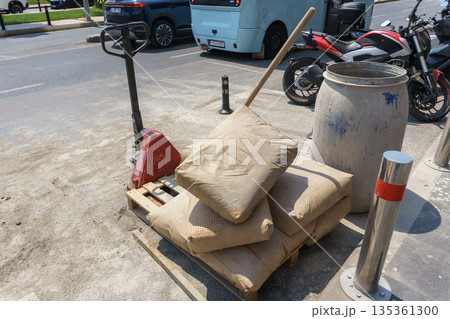Repair work on roads with bags of cement on a pallet. Repair work on roads with bags of cement on a pallet. 135361300