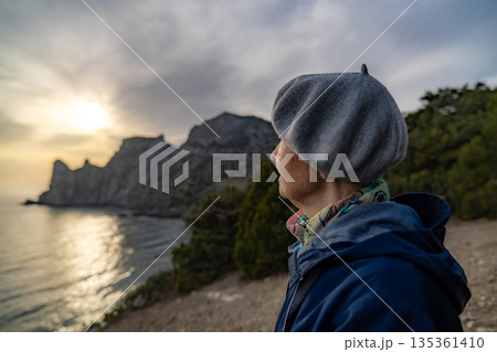 Senior woman nature view contemplating landscape mountains sunset ocean 135361410