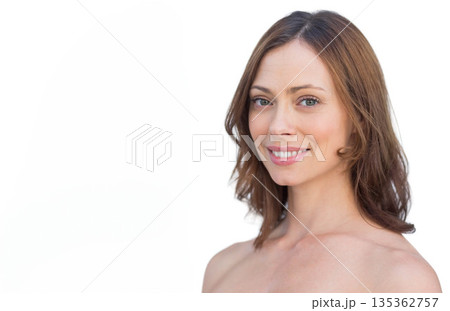 Woman smiling softly and posing with bare shoulders in studio white backdrop, copy space Woman smiling softly and posing with bare shoulders in studio white backdrop, copy space 135362757