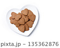 Heart-shaped gingerbread cookies on a white heart-shaped plate isolated on white background 135362876
