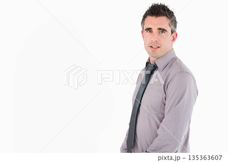 Man standing against white backdrop wearing light purple shirt and patterned necktie, copy space Man standing against white backdrop wearing light purple shirt and patterned necktie, copy space 135363607