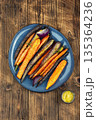 Vegetarian healthy food, baked carrots. 135364236