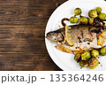 Fried trout with Brussels sprouts. 135364246