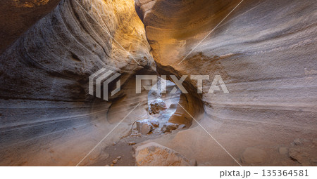 Desert slot canyon Barranco de las vacas showing narrow sedimentary rock walls Desert slot canyon Barranco de las vacas showing narrow sedimentary rock walls 135364581