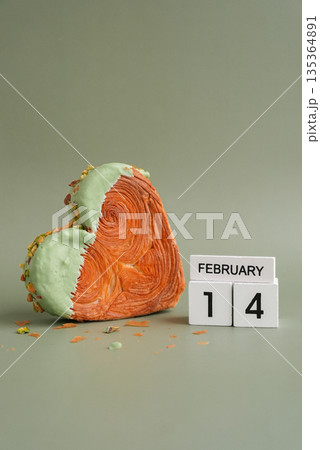 14 February Valentine's Day holiday Delightful and vibrant heartshaped pastry croissant treat, beautifully topped with colorful frosting nut galore. Mock up template copy space. Food experimentation 135364891