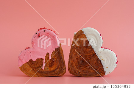 Delicious fresh croissant topped with colorful flavor Ganache. Creation unique heart shape bakery. Puff pastry holiday love gift present idea Valentine's day 135364953