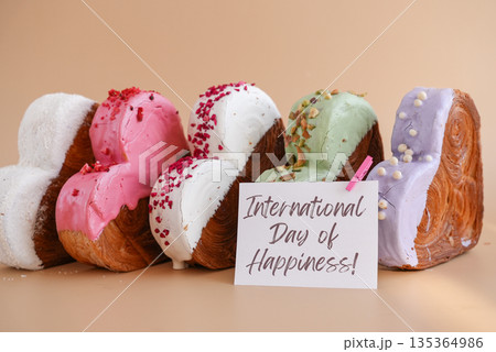 International day of happiness greeting card Delicious fresh croissant topped with colorful flavor Ganache. Creation unique heart shape bakery. Puff pastry holiday love gift present idea International day of happiness greeting card Delicious fresh croissant topped with colorful flavor Ganache. Creation unique heart shape bakery. Puff pastry holiday love gift present idea 135364986
