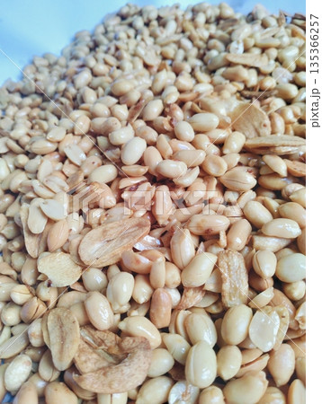 Roasted peanuts mixed with garlic as a traditional savory snack with crunchy texture and natural food background 135366257