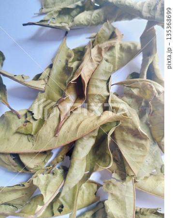 Aromatic dried bay leaves isolated on white background used as culinary herb and cooking spice Aromatic dried bay leaves isolated on white background used as culinary herb and cooking spice 135368699