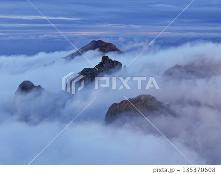 Misty mountain ridge at twilight, guides scouting view Misty mountain ridge at twilight, guides scouting view 135370608