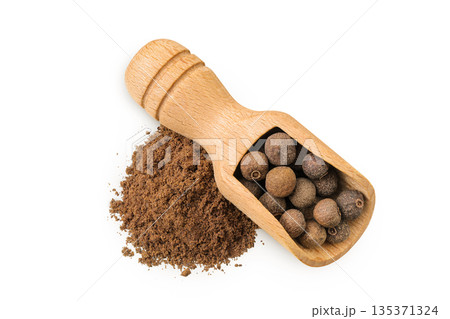 Allspice pepper and ground in wooden scoop isolated on white background. Jamaica pepper, Pimenta dioica or myrtle pepper. Top view Allspice pepper and ground in wooden scoop isolated on white background. Jamaica pepper, Pimenta dioica or myrtle pepper. Top view 135371324