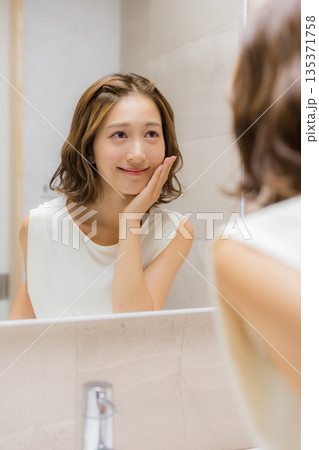 鏡を見る若い女性　 135371758