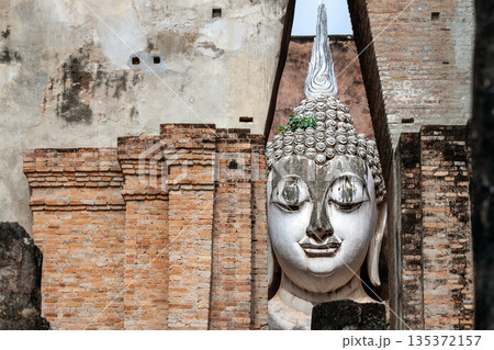 Big Buddha statue at Wat Si Chum temple in Sukhothai historical park Sukhothai, Thailand 135372157