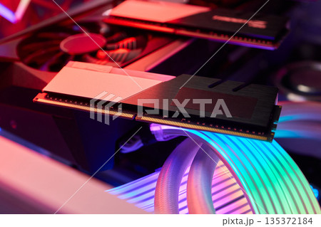 Elegant gaming hardware, High-performance RAM with cooling system, Premium illuminated memory module for gaming PCs, Sleek neon lit RAM with cooling and metallic heat sink design Elegant gaming hardware, High-performance RAM with cooling system, Premium illuminated memory module for gaming PCs, Sleek neon lit RAM with cooling and metallic heat sink design 135372184
