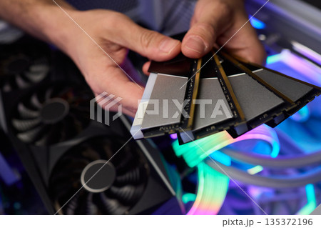 Computer hardware setup highlighting RAM sticks and graphics card details, Credentials for professional technical environment featuring RAM modules and GPU display Computer hardware setup highlighting RAM sticks and graphics card details, Credentials for professional technical environment featuring RAM modules and GPU display 135372196