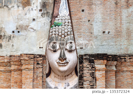 Big Buddha statue at Wat Si Chum temple in Sukhothai historical park Sukhothai, Thailand 135372324