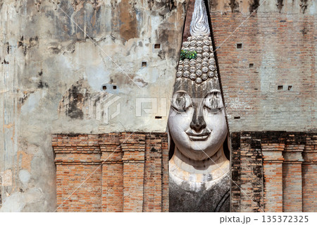 Big Buddha statue at Wat Si Chum temple in Sukhothai historical park Sukhothai, Thailand Big Buddha statue at Wat Si Chum temple in Sukhothai historical park Sukhothai, Thailand 135372325