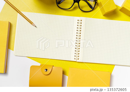 Notebook and stationery on a yellow background for study and creative work Notebook and stationery on a yellow background for study and creative work 135372605