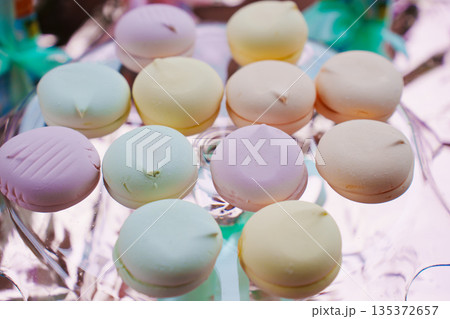 Colorful macaroons on a clear dish at a dessert table 135372657