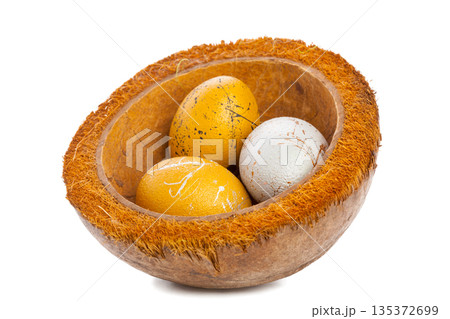 Colorful eggs placed in a coconut bowl for decoration at spring celebration event 135372699