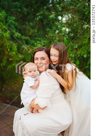 Family portrait in a garden with children and mother 135372741