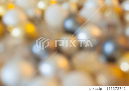 Close-up of blurred beads in different colors and sizes scattered on a surface Close-up of blurred beads in different colors and sizes scattered on a surface 135372742