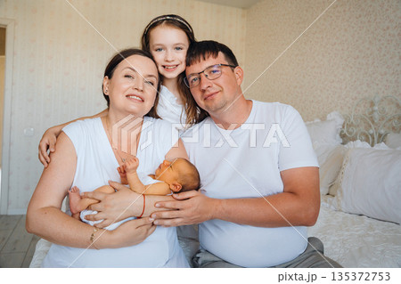 Family spends time together at home with newborn baby 135372753