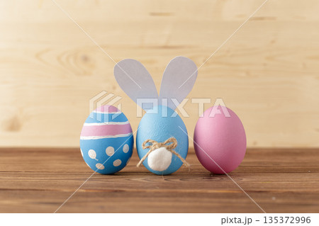 Colorful eggs and bunny decoration for Easter celebration on wooden table 135372996