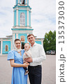 Family poses together in front of blue church 135373030